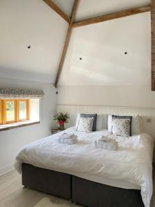 a bedroom with a large white bed in a room at The Granary, Norfolk in Norwich