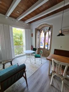 a living room with a table and chairs at Pensión A Xanela in Pontevedra