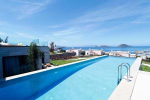 a swimming pool with a view of the ocean at Vistaport A - Luxury Villa in Bodrum City