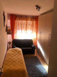 a living room with a couch and a window at Alessia Apartments in Râşnov