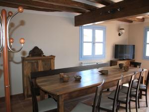 a dining room with a wooden table and chairs at Ca de Costa in El Pont de Suert