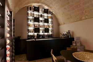 a bar in a restaurant with a wall of wine glasses at Le Carasse Boutique Hotel in Mola di Bari +57 photos