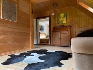 a living room with a black rug on the floor at Frein Chalets - Kaltenbach in Frein