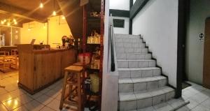 uma escada que leva a um restaurante com uma mesa e uma escada em CoffeeBunk Hostel em Tangerang mais 37 fotografias