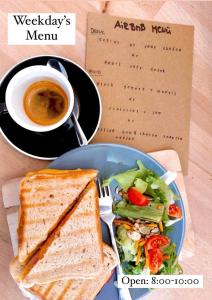 a sandwich and a salad and a cup of coffee at Historic Rooms near Gozsdu Udvar in Budapest