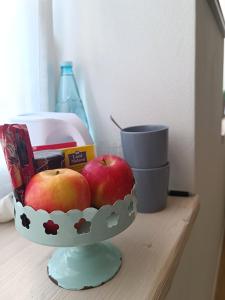 Deux pommes dans un bol au-dessus d'une table dans l'établissement Stanza Allegra Soave, à Soave