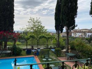 a view of a swimming pool from a balcony at Quattro Gigli Palace in Montopoli in Val dʼArno