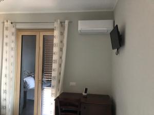 a room with a room with a door and a air conditioner at B&B Rosa dei Venti in Roseto Capo Spulico