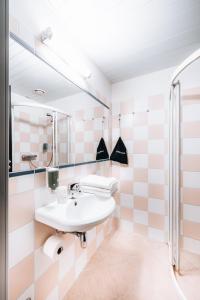 a bathroom with a sink and a mirror at Hotel NOSPA in Kuressaare