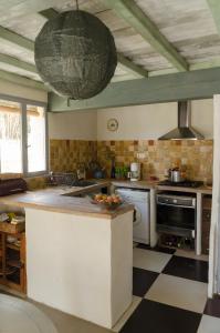 a kitchen with a counter and a large ball hanging from the ceiling at L'Oustaou des Monges in Mollans-sur-Ouvèze