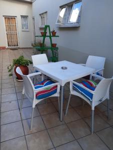 a white table and chairs on a patio at Sleep@161 Benade Drive in Bloemfontein