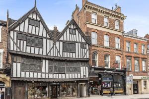 an old black and white building on a city street at Rowntree One - Stunning Apartment- Grade II listed in York