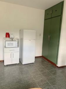 a kitchen with a white refrigerator and a microwave at Departamento Temporario calle Pico 1 in Santa Rosa