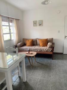 a living room with a couch and a table at Departamento Temporario calle Pico 1 in Santa Rosa