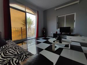 a living room with a black and white checkered floor at Estrela do Mar - Beachfront in Vila do Maio