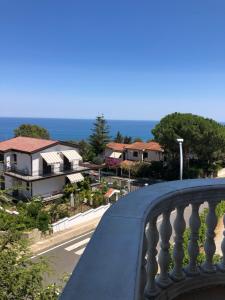 a balcony with a view of a street and houses at B&B Rosa dei Venti in Roseto Capo Spulico
