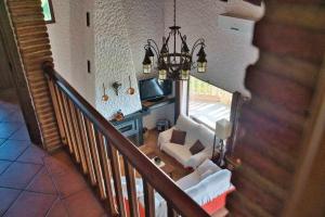 a staircase with a living room with a chandelier at El Valle Dorado in El Gastor