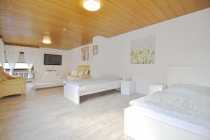 a bedroom with two white beds and a tv at Work & Stay in Sankt Augustin near Troisdorf in Sankt Augustin