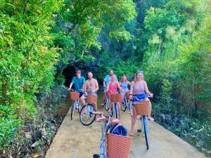 a group of people riding bikes on a trail at Viet Hai Lan Homestay in Cat Ba
