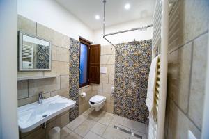 a bathroom with a sink and a toilet and a shower at Irpinia BikeHouse in Montella +7 photos