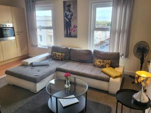 a living room with a couch and a table at & Cosy Apartment in the heart of Stokes Croft in Bristol