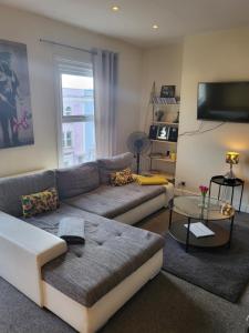 a living room with a couch and a table at & Cosy Apartment in the heart of Stokes Croft in Bristol