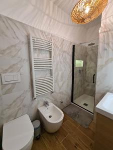 a bathroom with a sink and a toilet and a shower at La Boheme, 2 min da Qc terme, free parking in San Pellegrino Terme