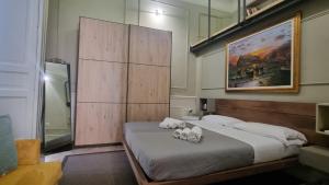 a bedroom with a large bed with towels on it at Vico Gelso Napoli in Naples