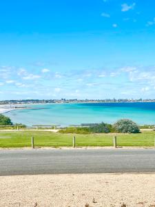 a road with a view of a body of water at SALT @ North Beach WALLAROO (absolute beachfront) in Wallaroo
