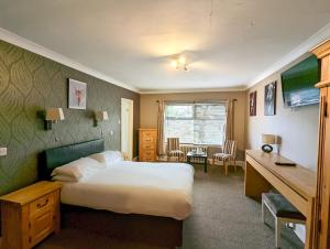 a hotel room with a bed and a desk at Hotel Celebrity in Bournemouth