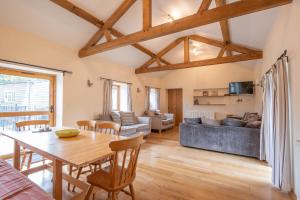 a living room with a table and a couch at The Stables in Bromyard