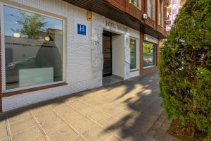 a store front with its doors open on a sidewalk at Hotel Navarro in Ciudad Real