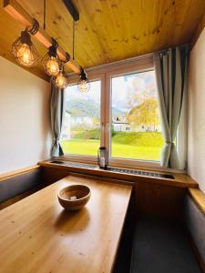 a wooden table in a room with a window at Wellness-Apartment Seefeld and Chill SPA im Zentrum mit Pool, Sauna und Netflix for free in Seefeld in Tirol