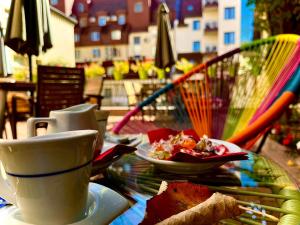 a table with a cup of coffee and a plate of food at Hotel Adria in Sofia +51 photos