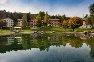 a large lake in front of a building at Pradas Resort Brigels in Breil/Brigels