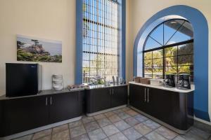 a room with a tv and a window at Studio 6 Suites Cameron Park, CA Folsom in Cameron Park