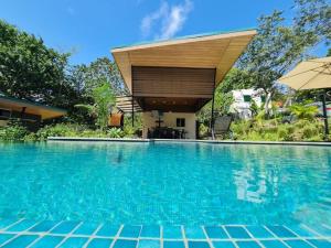 a swimming pool in front of a house at Eco Lung Hotel in Montezuma