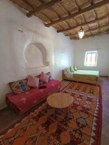 a living room with a couch and a table at Auberge Bassou in Nkob