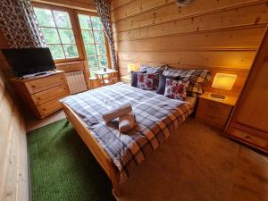1 dormitorio con 1 cama en una cabaña de madera en GliczarowSki u Zbója, en Zakopane