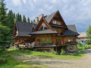 Cabaña de madera con techo negro en GliczarowSki u Zbója, en Zakopane