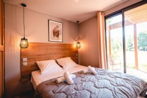 a bedroom with a bed with two stuffed animals on it at Rives d'Arc in Vallon-Pont-dʼArc