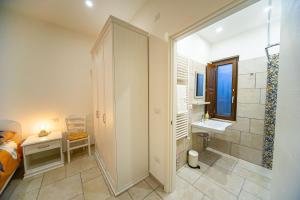 a small bathroom with a shower and a sink at Irpinia BikeHouse in Montella