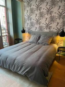 a large bed in a bedroom with a wall at Spa & Detente - Cinéma - Netflix - Hyper Centre in Arras