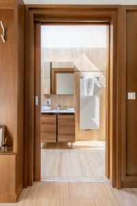 a bathroom with a sink and a mirror at Botrytis Borhotel in Mád