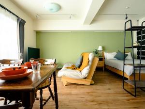 a living room with a bed and a table at Home n Lounge in Tokyo +257 photos