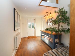 a hallway with a blue dresser and a potted plant at Hall Farm in Market Rasen