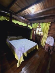 a bedroom with a bed with two rings on it at Cabañas Montañas del Tenorio in San Rafael