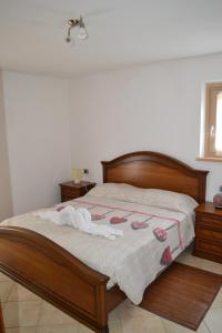 a bedroom with a bed with towels and slippers on it at Agritur Agribaldo Lavanda in Brentonico