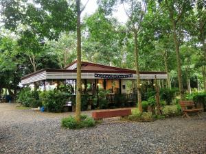 a small building in the middle of a park at Sameikei Homestay in Phrae +22 photos