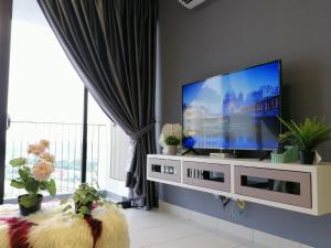 a living room with a large flat screen tv at Astetica Residences @ Seri Kembangan in Seri Kembangan